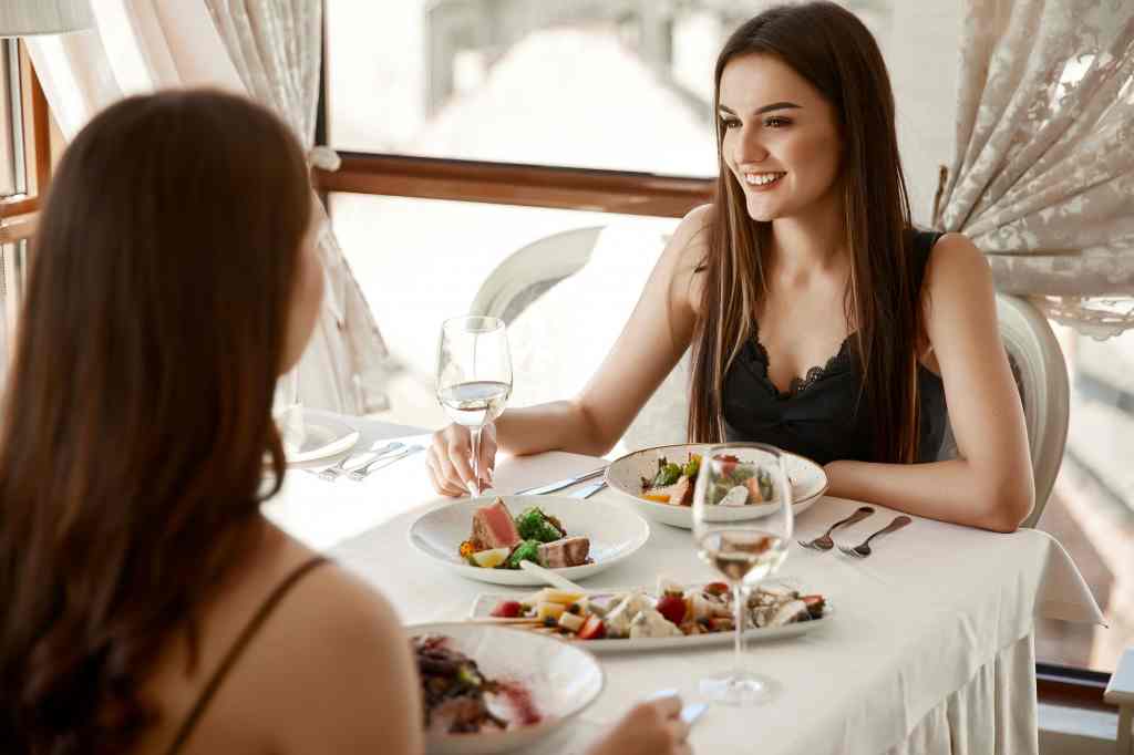 Woman experiencing fine dining during travel